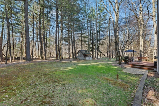 view of yard with a wooden deck and an outdoor structure