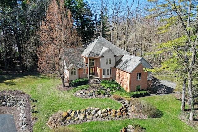 view of front facade with a front lawn and brick siding