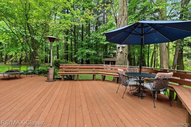 5721 Coralwood Ct, Commerce Twp, MI 48382 - wooden terrace with an outdoor fire pit and outdoor dining space