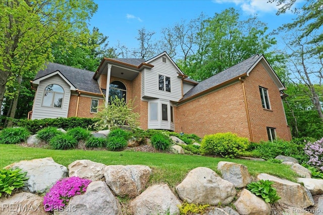 5721 Coralwood Ct, Commerce Twp, MI 48382 - traditional-style house featuring brick siding and a shingled roof