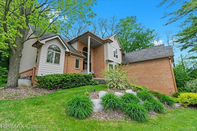 5721 Coralwood Ct, Commerce Twp, MI 48382 - view of front of house featuring brick siding and a front lawn