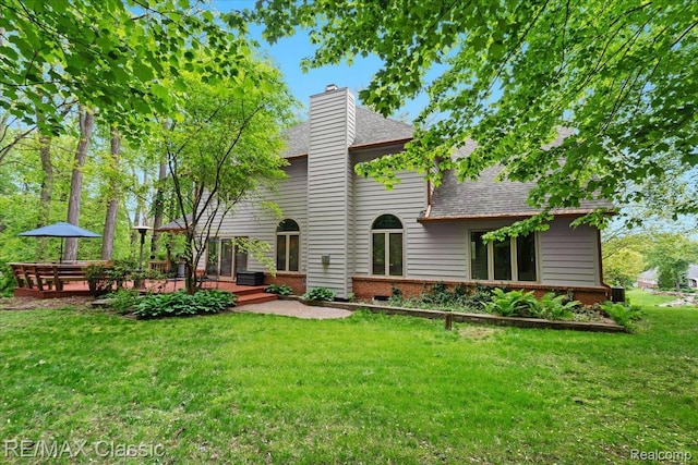 5721 Coralwood Ct, Commerce Twp, MI 48382 - back of house with a shingled roof, a yard, brick siding, and a chimney