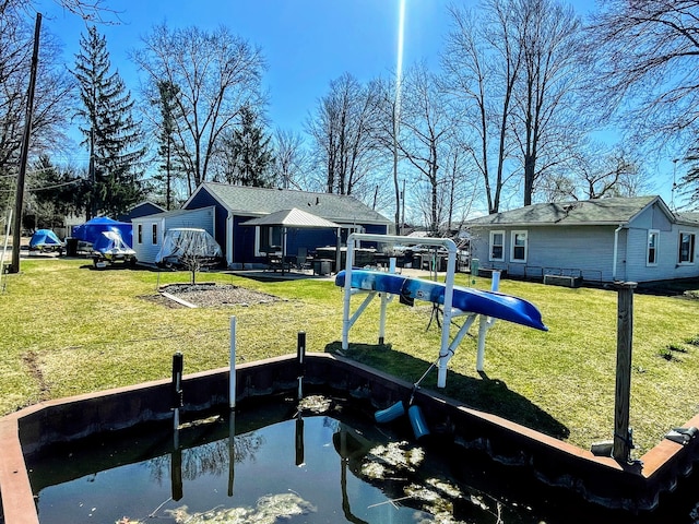 view of dock with a yard
