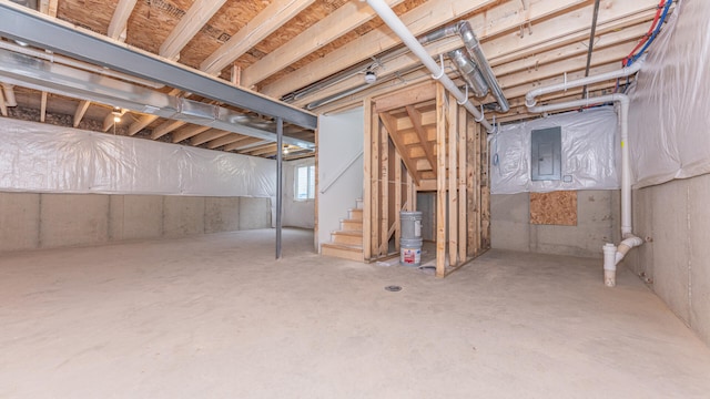 below grade area featuring electric panel and stairway
