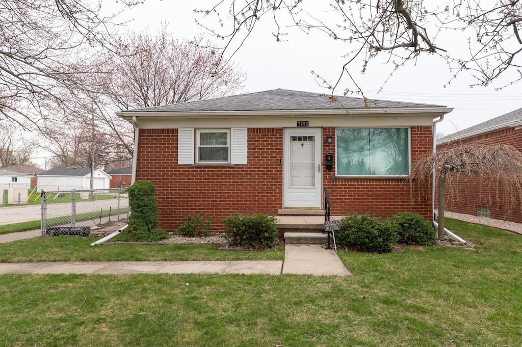 7252 Luana Ave, Allen Park, MI 48101 - bungalow-style house featuring a front yard, fence, and brick siding