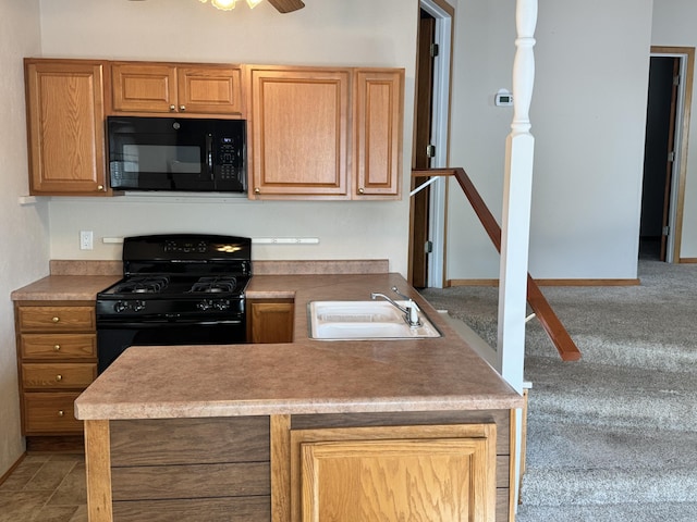 170 Tuttle Park Dr, Sherwood, MI 49089 - kitchen featuring black appliances, a sink, a peninsula, carpet flooring, and ceiling fan