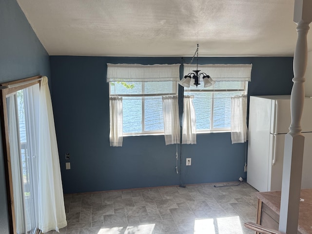 170 Tuttle Park Dr, Sherwood, MI 49089 - unfurnished dining area with a chandelier and stone finish flooring