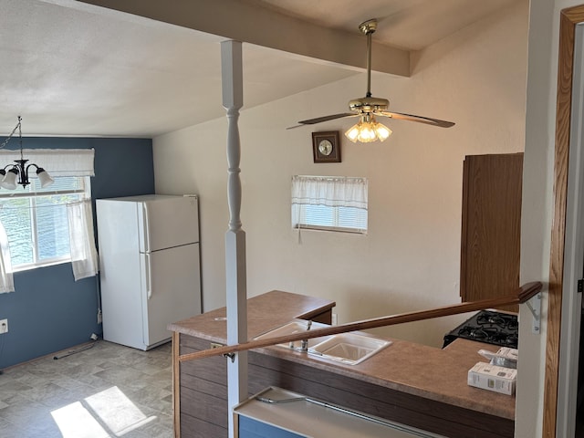 170 Tuttle Park Dr, Sherwood, MI 49089 - kitchen featuring freestanding refrigerator, a ceiling fan, and a chandelier