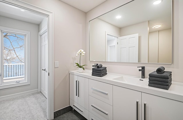 6376 Sterling Dr, Newport, MI 48166 - bathroom with double vanity, a sink, baseboards, and recessed lighting