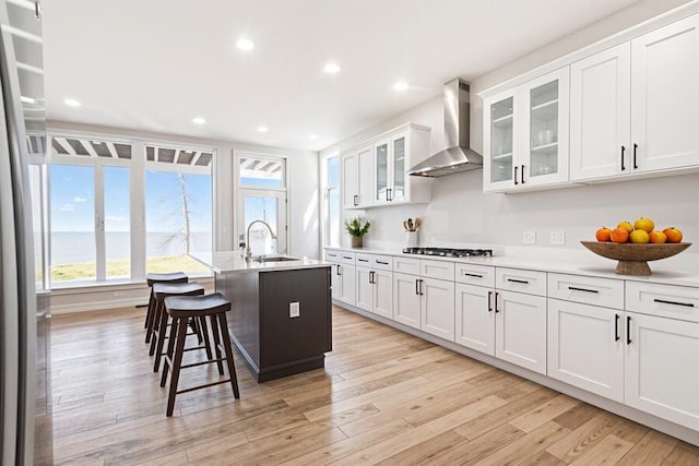 6376 Sterling Dr, Newport, MI 48166 - kitchen with light wood-style floors, a sink, wall chimney range hood, and gas cooktop