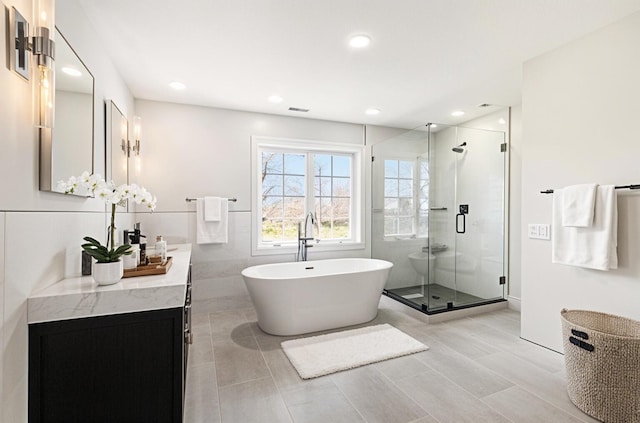 6376 Sterling Dr, Newport, MI 48166 - full bath with a shower stall, a freestanding tub, vanity, and recessed lighting