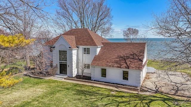 6376 Sterling Dr, Newport, MI 48166 - exterior space with a water view, a front lawn, a shingled roof, and stucco siding