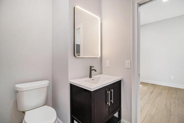 6376 Sterling Dr, Newport, MI 48166 - bathroom with toilet, wood finished floors, vanity, and baseboards
