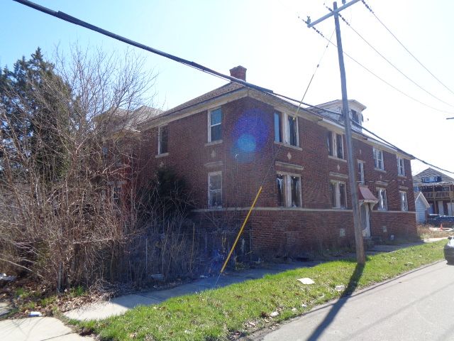 7538 Firwood St, Detroit, MI 48204 - view of side of property with a chimney and brick siding