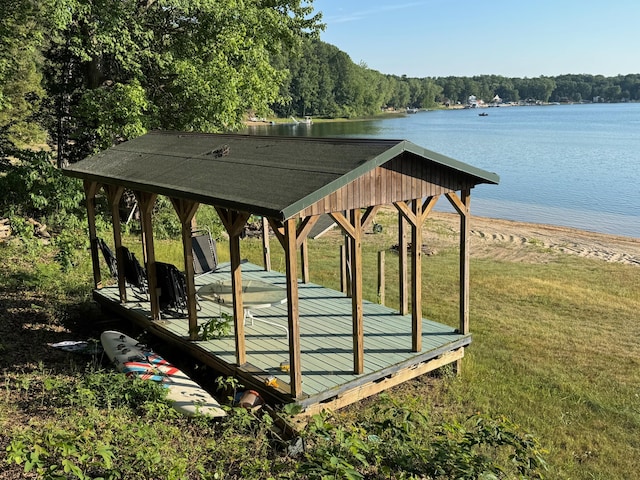 7075 N Poplar Rd, Michigan, MI 49411 - surrounding community featuring a lawn, a water view, and a wooded view