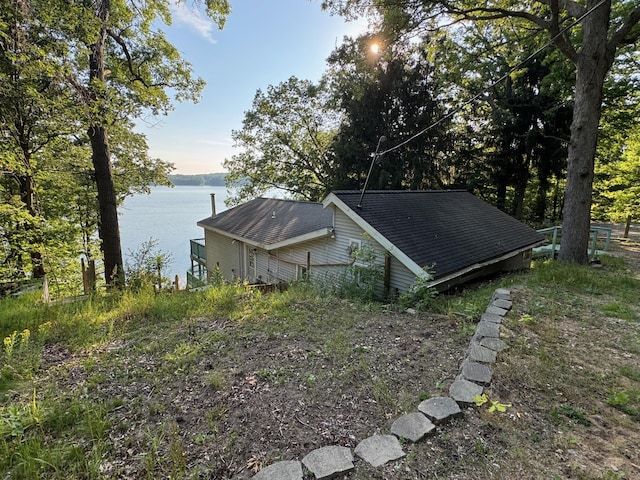 7075 N Poplar Rd, Michigan, MI 49411 - view of property exterior with a water view and a shingled roof
