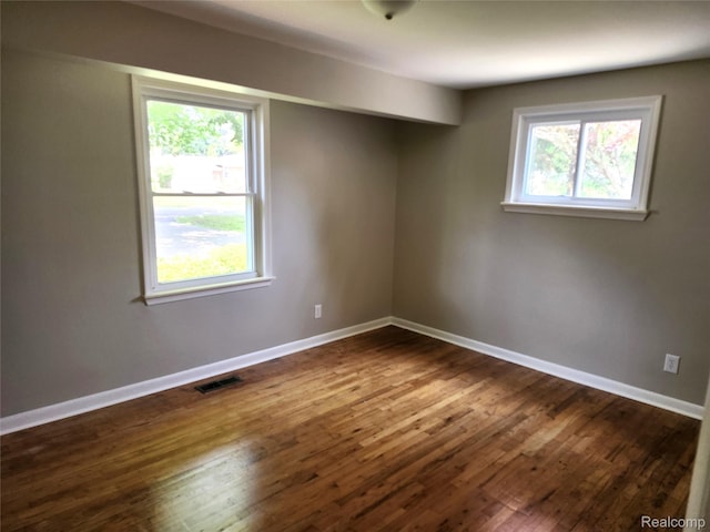 1260 Hira St, Waterford, MI 48328 - unfurnished room with dark wood-type flooring and baseboards