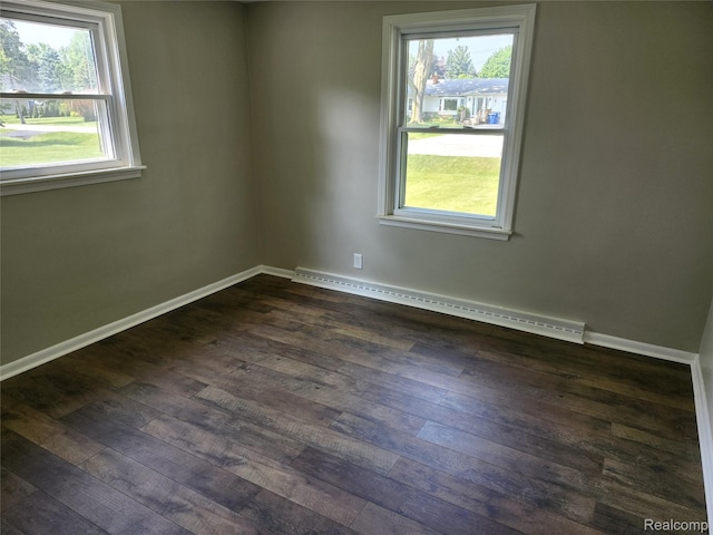 1260 Hira St, Waterford, MI 48328 - unfurnished room with baseboard heating and dark wood finished floors