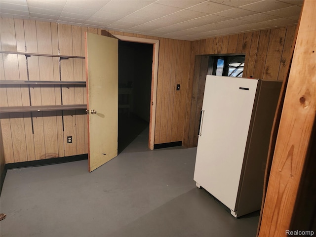 1260 Hira St, Waterford, MI 48328 - below grade area with freestanding refrigerator and wooden walls