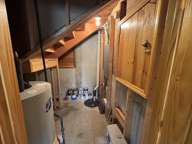 interior space featuring gas water heater, electric panel, and stairway