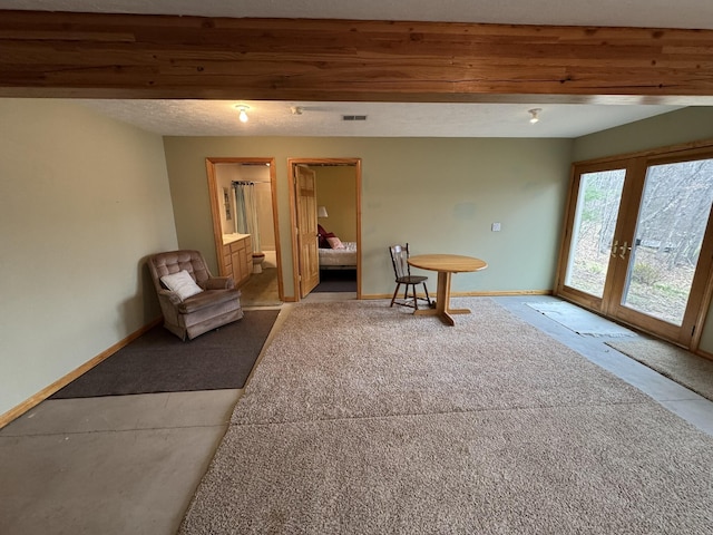 living area featuring carpet floors, baseboards, french doors, and visible vents