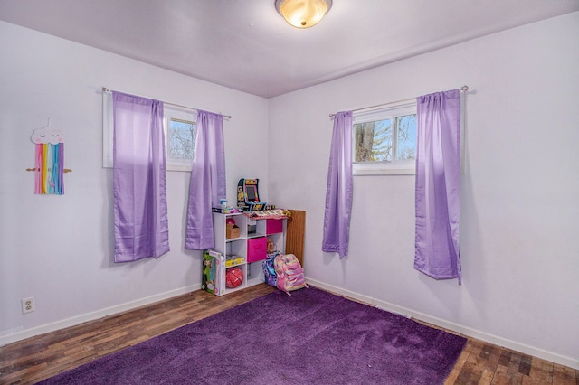 rec room with a wealth of natural light, wood finished floors, and baseboards