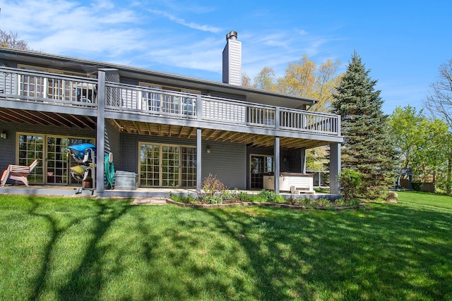 11183 Bayshore Ct, Clarkston, MI 48348 - back of property with a deck, a yard, a chimney, and a patio area