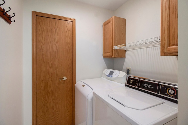 11183 Bayshore Ct, Clarkston, MI 48348 - washroom featuring separate washer and dryer and cabinet space