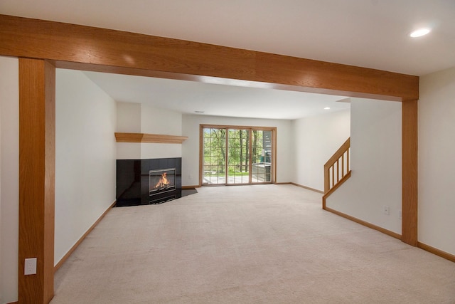 11183 Bayshore Ct, Clarkston, MI 48348 - unfurnished living room featuring a fireplace with flush hearth, light colored carpet, baseboards, recessed lighting, and stairs