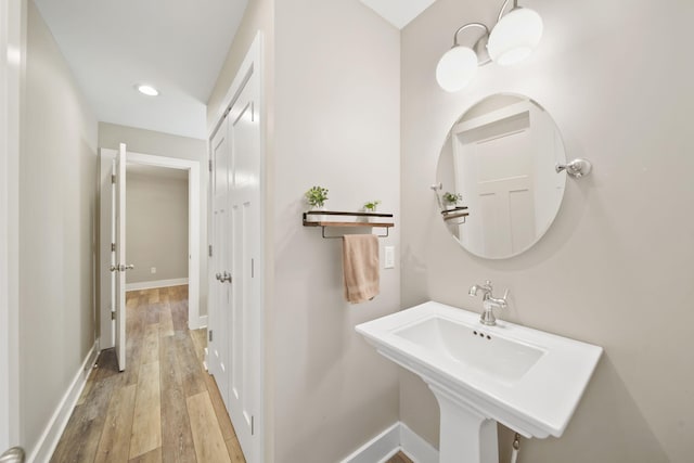 bathroom featuring recessed lighting, baseboards, and hardwood / wood-style flooring