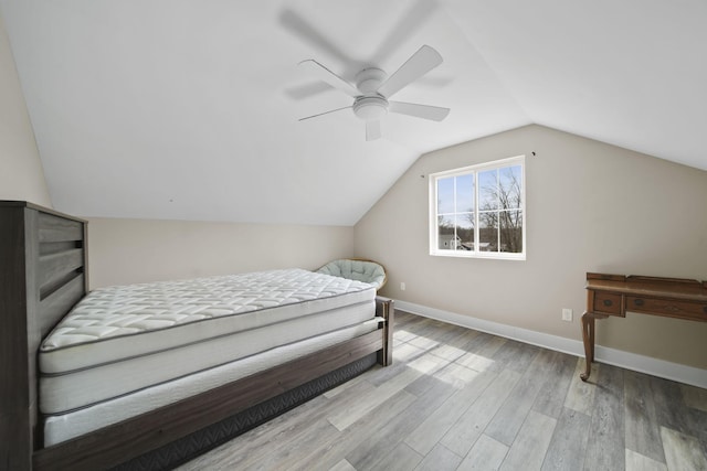 bedroom featuring baseboards, a ceiling fan, wood finished floors, and lofted ceiling