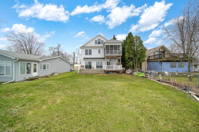 rear view of property featuring fence, a wooden deck, a sunroom, and a lawn
