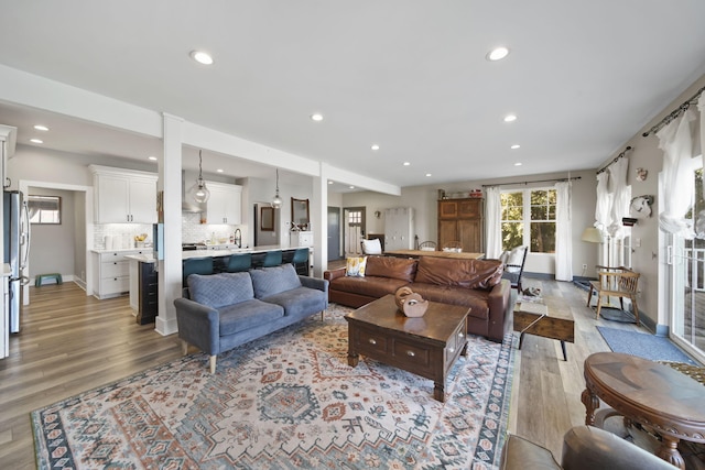living area with recessed lighting and light wood-style floors