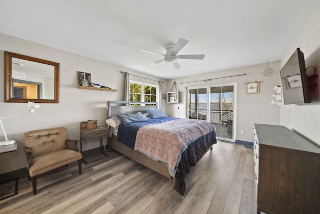 bedroom featuring light wood-style floors, ceiling fan, visible vents, access to exterior, and baseboards