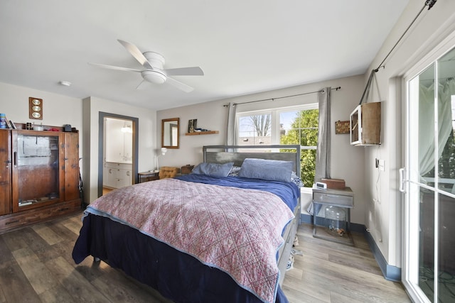 bedroom featuring a ceiling fan, ensuite bath, and wood finished floors