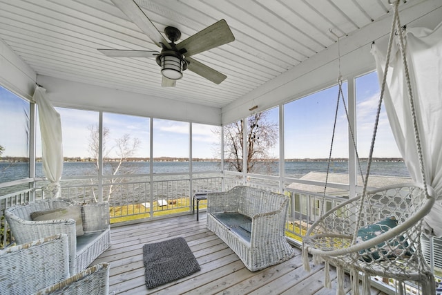 sunroom with a water view and a ceiling fan