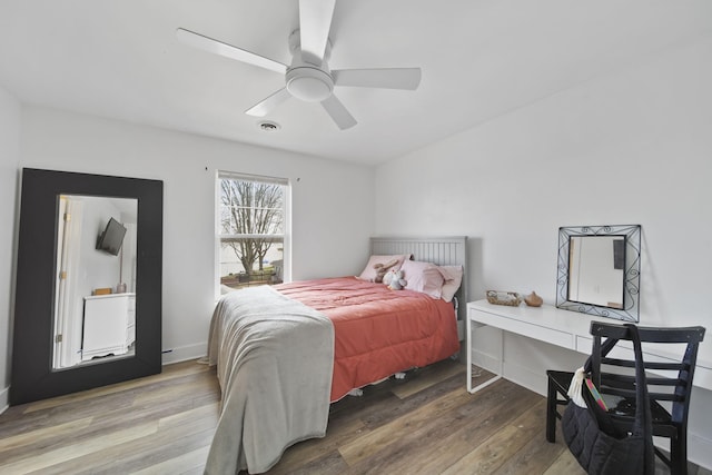bedroom with visible vents, a ceiling fan, and wood finished floors