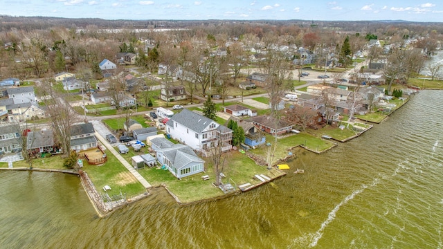 birds eye view of property with a water view and a residential view