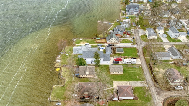 drone / aerial view featuring a water view and a residential view