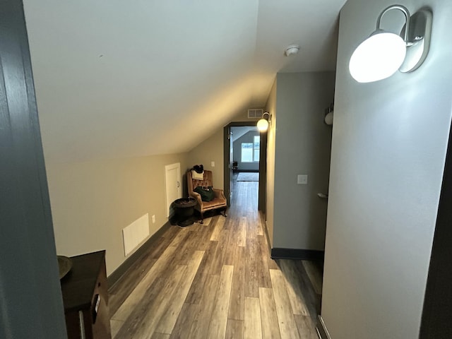 bonus room with visible vents, wood finished floors, and lofted ceiling