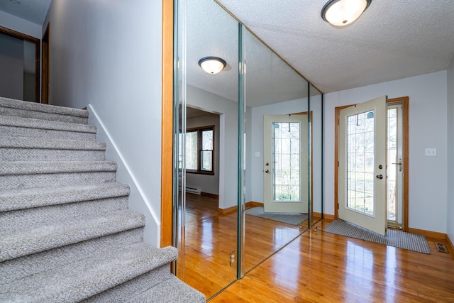 2532 Ridgewood Trl, Berrien Springs, MI 49103 - entryway with baseboards, stairway, wood finished floors, and a textured ceiling