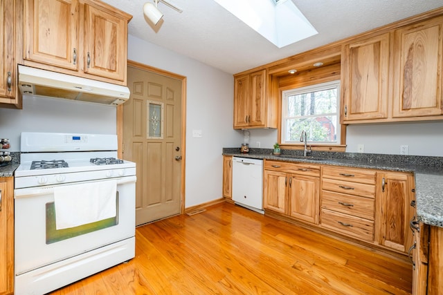 2532 Ridgewood Trl, Berrien Springs, MI 49103 - kitchen with white appliances, a skylight, under cabinet range hood, a sink, and light wood finished floors