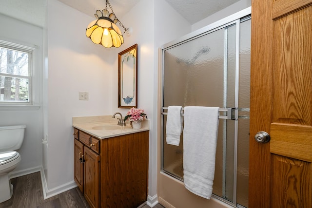 2532 Ridgewood Trl, Berrien Springs, MI 49103 - full bathroom with baseboards, toilet, enclosed tub / shower combo, vanity, and wood finished floors