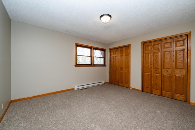 2532 Ridgewood Trl, Berrien Springs, MI 49103 - unfurnished bedroom featuring baseboard heating, two closets, carpet flooring, and baseboards