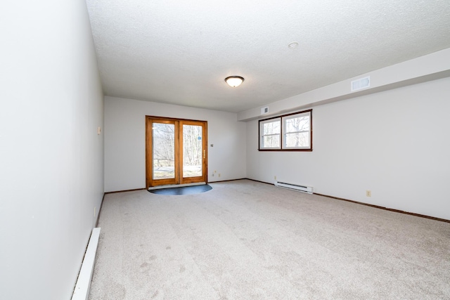 2532 Ridgewood Trl, Berrien Springs, MI 49103 - carpeted spare room featuring a textured ceiling, visible vents, a baseboard heating unit, a baseboard radiator, and baseboards