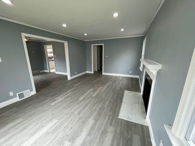 4651 Berkshire St, Detroit, MI 48224 - unfurnished living room with wood finished floors, visible vents, and crown molding