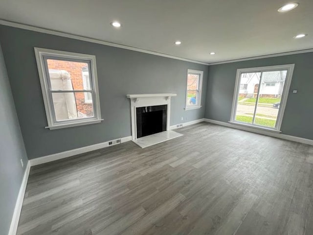 4651 Berkshire St, Detroit, MI 48224 - unfurnished living room with recessed lighting, wood finished floors, visible vents, ornamental molding, and baseboards