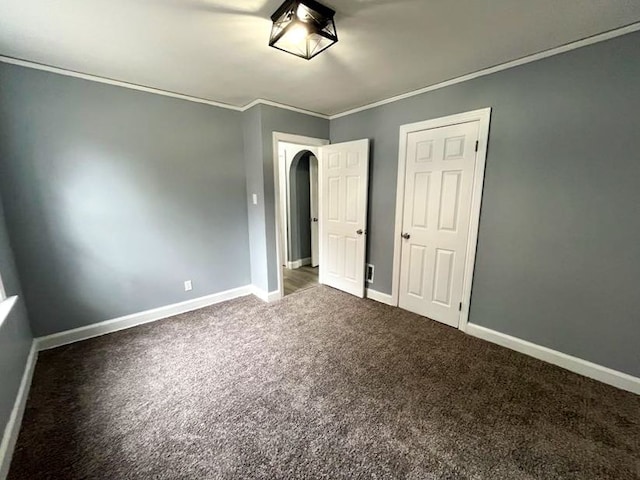 4651 Berkshire St, Detroit, MI 48224 - unfurnished bedroom with arched walkways, baseboards, carpet floors, and crown molding