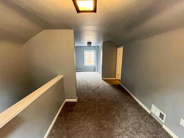 4651 Berkshire St, Detroit, MI 48224 - hallway with vaulted ceiling, baseboards, visible vents, an upstairs landing, and carpet floors