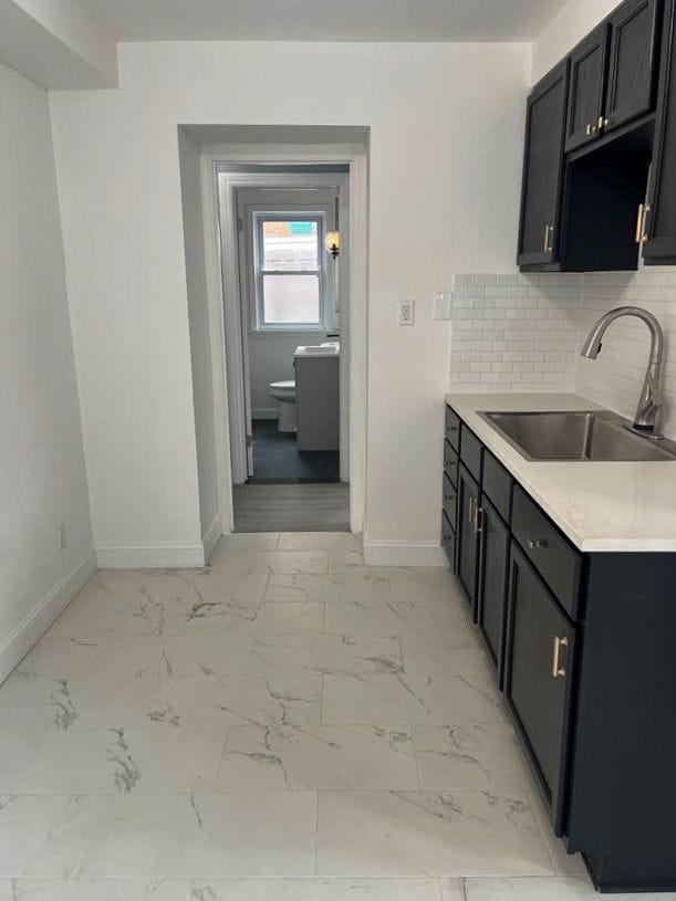 4651 Berkshire St, Detroit, MI 48224 - kitchen with light countertops, baseboards, a sink, and marble finish floor